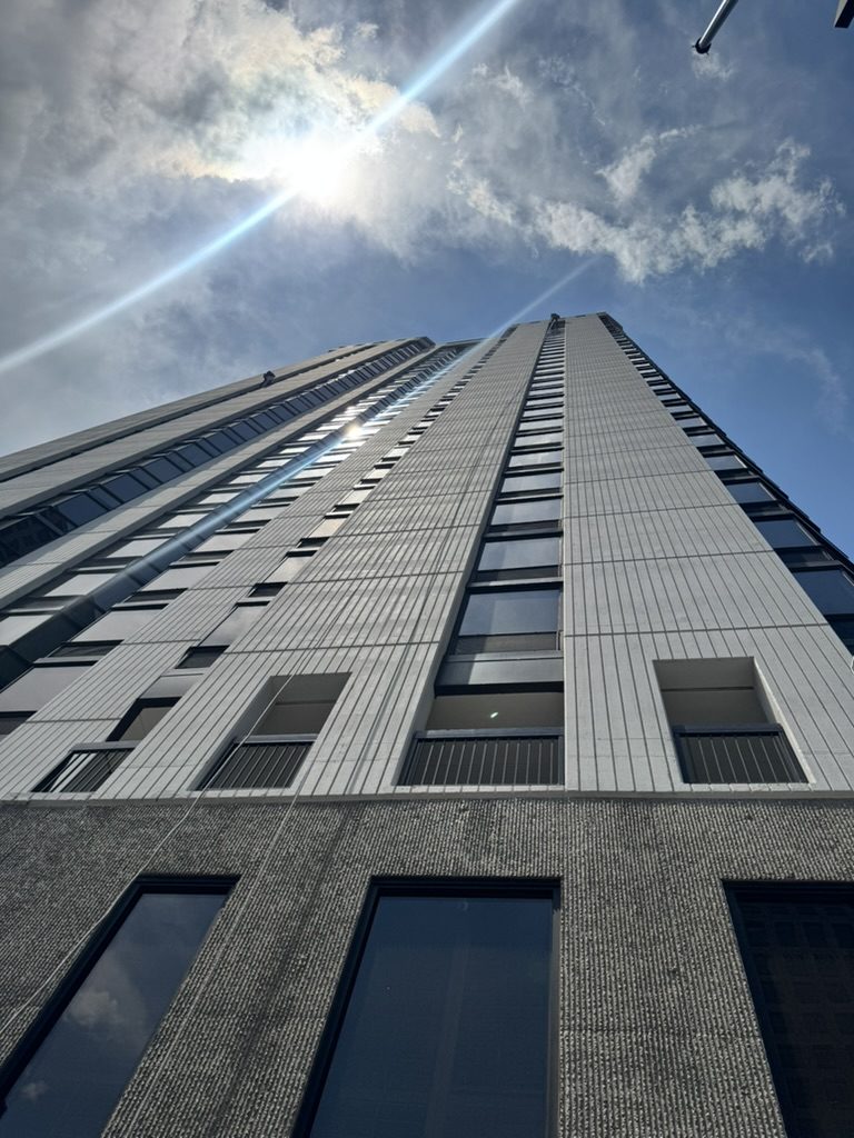 Looking up the glass facade of a high-rise building